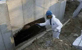 Professional waterproofing the exterior walls of the basement in Sioux Falls, SD