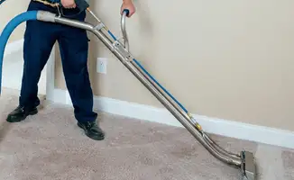 Professional operating a liquid removal machine on a carpeted floor in Sioux Falls, SD